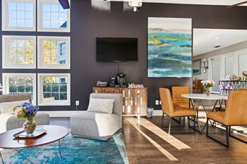 a living room with a couch and chairs and a table and a television at Ashton Creek, Chester, Virginia